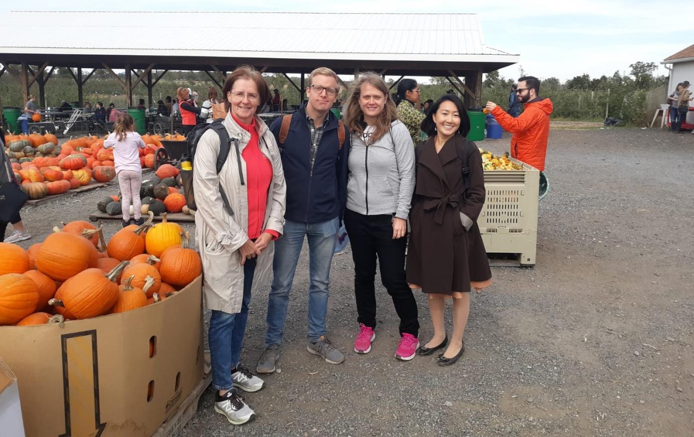 Photo of four scholars in a pumkin field, for MCPD grantee blog