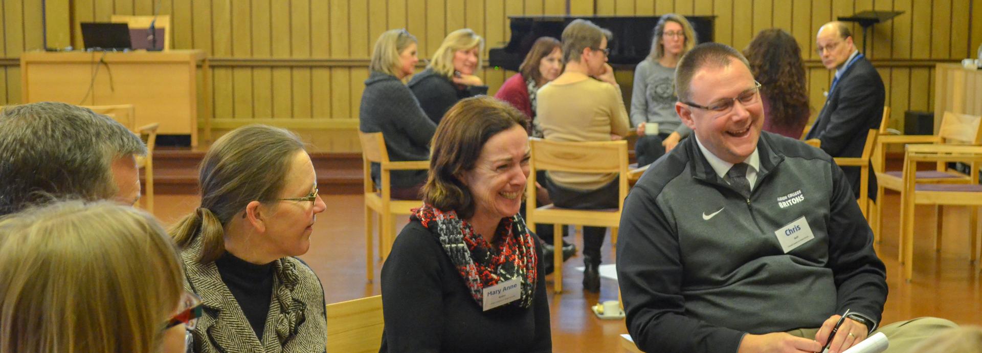 Two Fulbright Leaders for Global Schools participants laughing during a small group discussion in the Seminarium Festival hall at the University of Jyväskylä