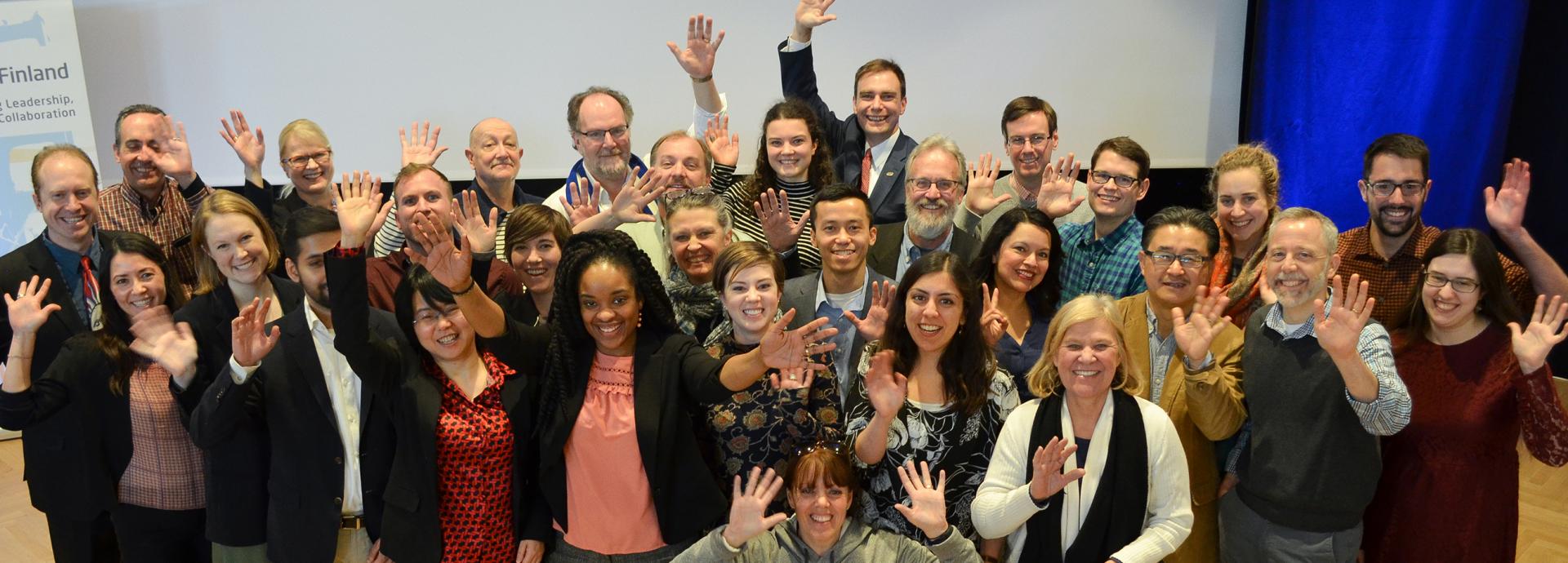 Group of U.S. Fulbright grantees happily waving after a seminar