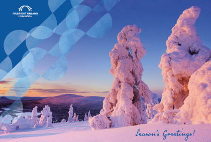 A wintery view, taken in Lapland, Finland. There is a lot of snow on trees, and a fell can be seen in the background. Sun is shining from low, coloring the photo in reds and yellows. There is a Fulbright Finland Foundation logo on the right and it says "Season's Greetings!" on the bottom.