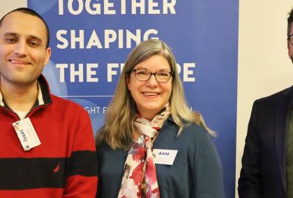 Isaac Farhadian, Anne Boyette, and Ryan Lewis in front of the Fulbright Finland Foundation's roll-up.