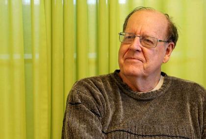 Professor Jim Fairweather in front of a lime green curtain