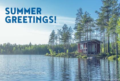 A red summer house on a lake with text "Summer Greetings!" and "Fulbright Finland Foundation" written on it. Photo: Juho Luomala / Unsplash