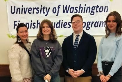 Four people standing in front of a banner which says "University of Washington, Finnish Studies Program"