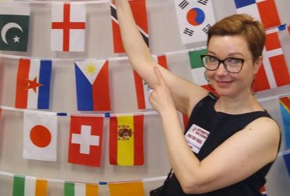 Person pointing at flags on the wall