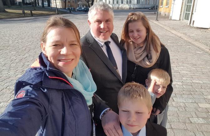 Bickford family selfie. Fulbright Specialists Sonja and Nate Bickford with their three children smiling at the camera.