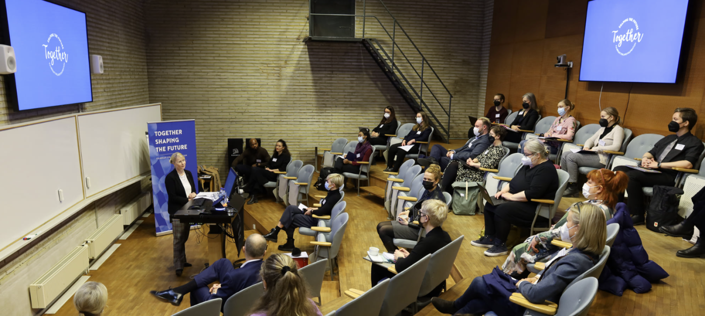 Audience in an auditorium listening to CEO Terhi Mölsä's remarks.