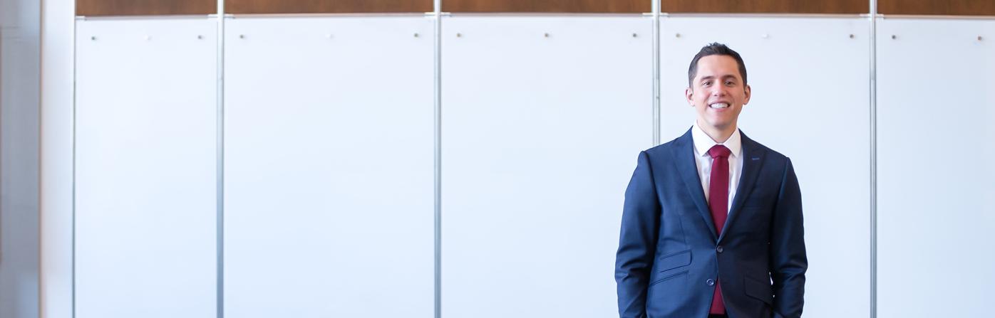 Ramón Barthelemy in a room with white background, smiling at the camera.