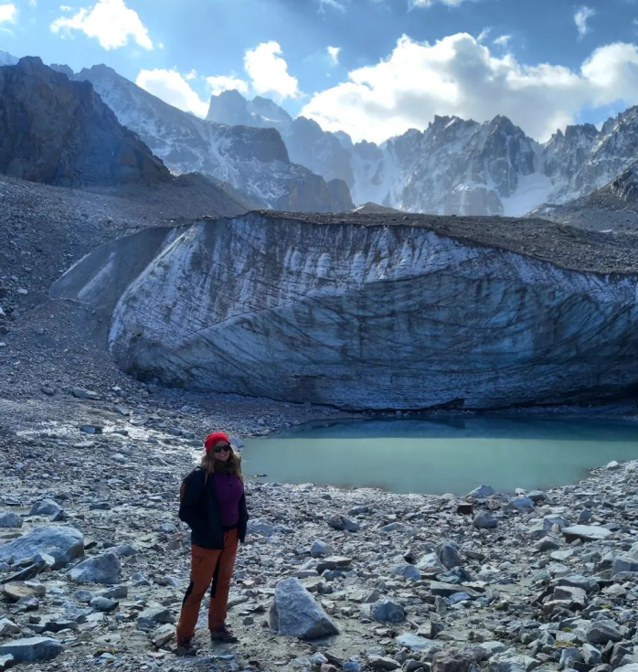 Riikkamari standing in front of a big glacier on a sunny day