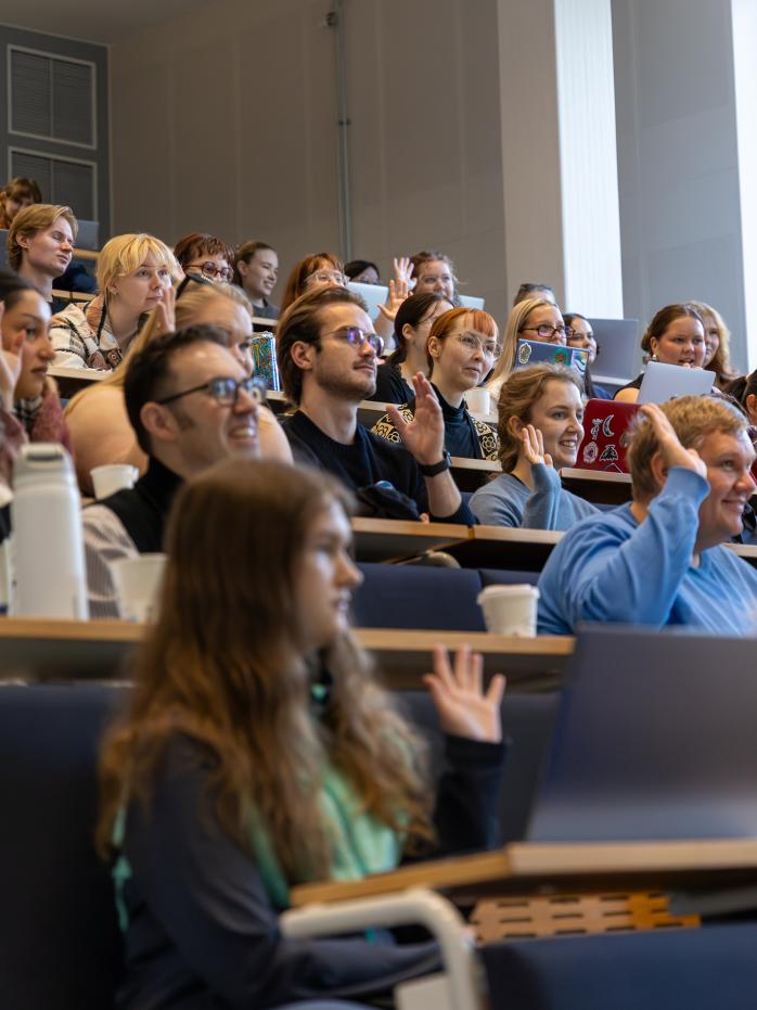 Audience laughing and raising hands