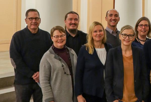 Leading scholars from Finland, the United States, the United Kingdom, and Germany in a group photo taken at the lobby of the main building of the University of Helsinki.