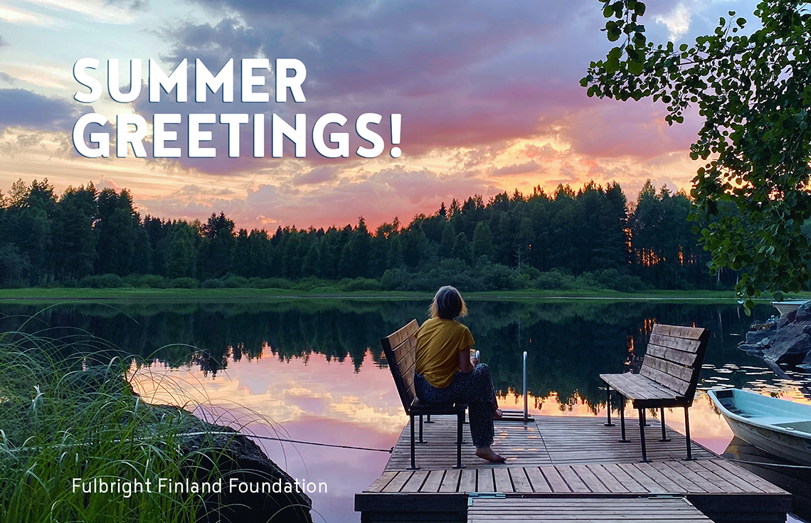 A person sitting on a chair on a pier during a summer evening. There is a forest behind the lake and the sky has colors of orange, blue, and purple. It says "Summer greetings!" on the upper left corner and Fulbright Finland Foundation on the lower left corner.