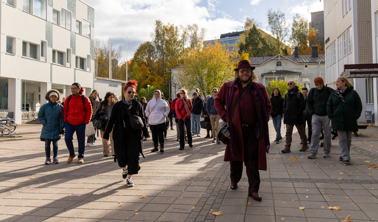 Group of Fulbright Finland grantees and alumni at the campus of the University of Turku on a sunny fall day.