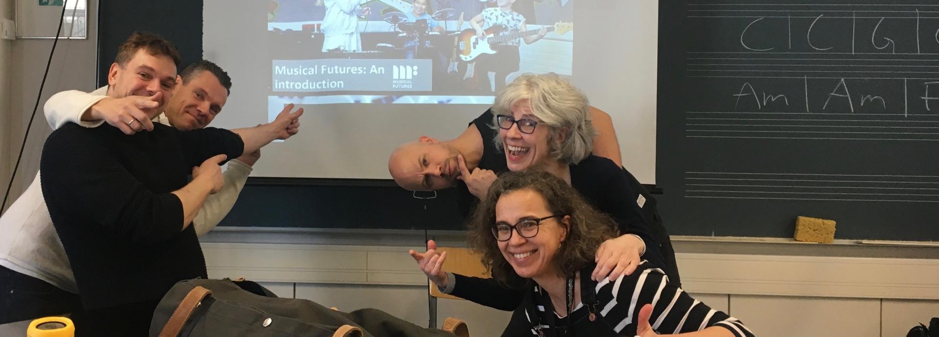 Fulbright Finland Inter-Country Travel Grantee Loralie Heagy with a group of music teacher making funny faces in a class room