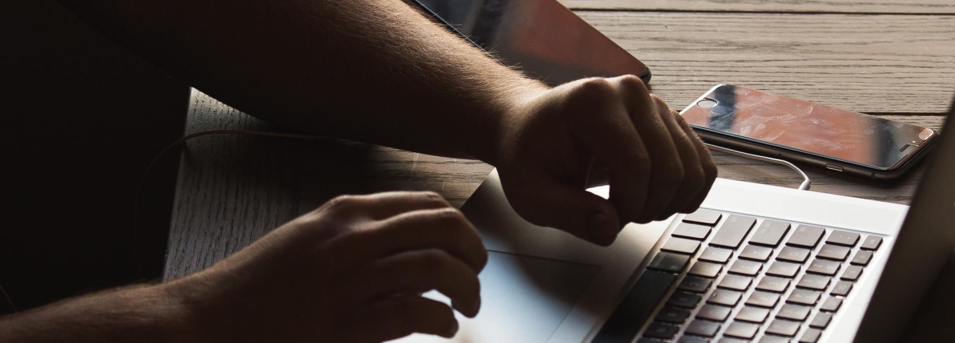 Stock photo of man using a laptop