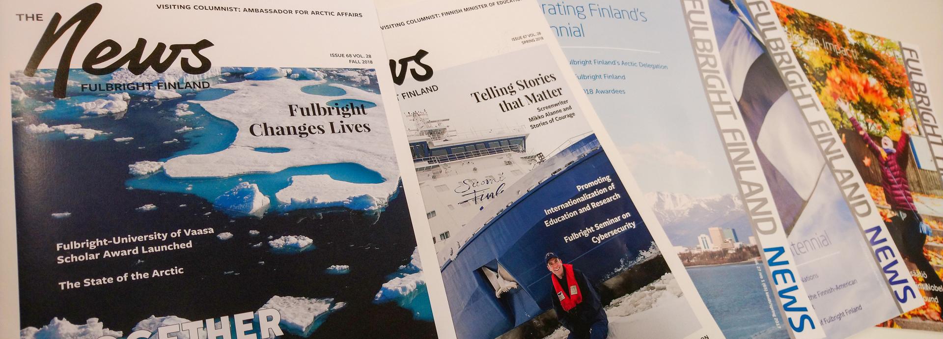 Selection of Fulbright Finland News magazine covers on a table