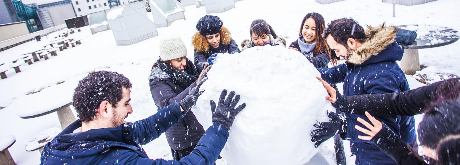 International students playing in the snow at Tampere University in Finland.