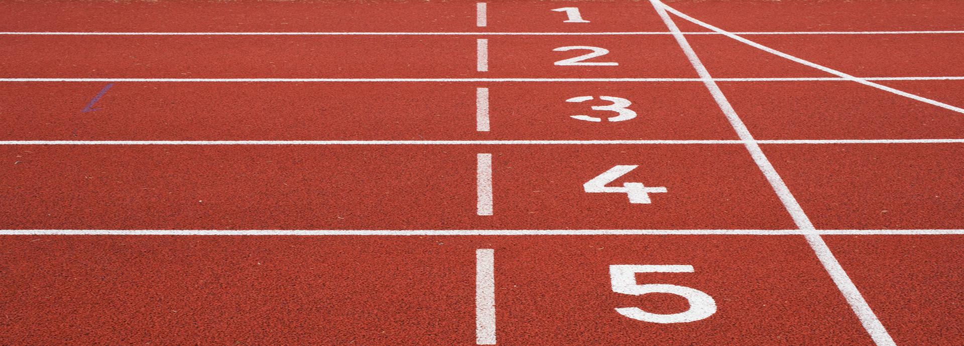Starting line on a running track, showing numbers from 1 to 5.