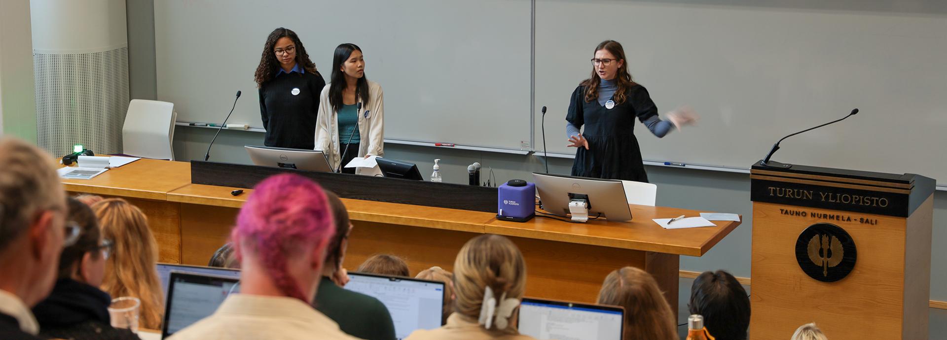 Fulbright U.S. Students Claudia Partridge, Skye Pham, and Chase Friel presenting at the 30th American Voices seminar at the University of Turku.