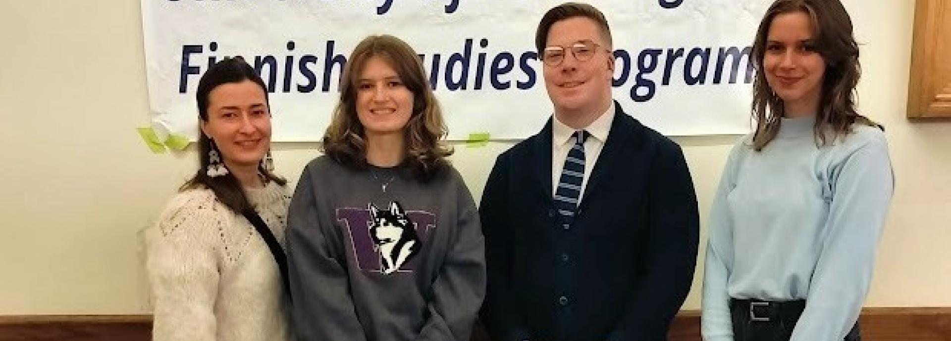 Four people standing in front of a banner which says "University of Washington, Finnish Studies Program"