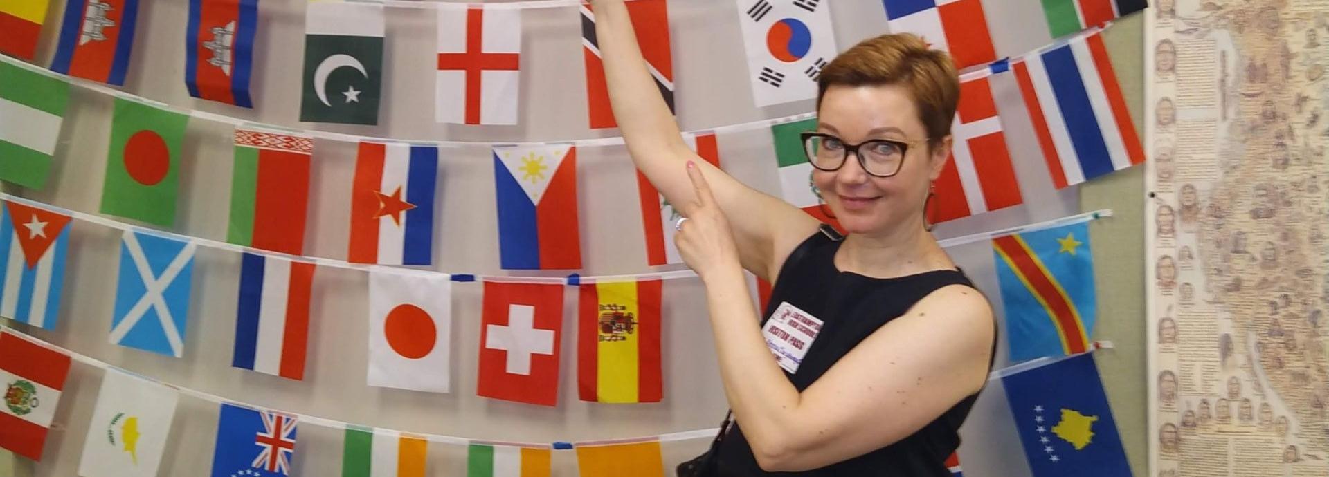 Person pointing at flags on the wall