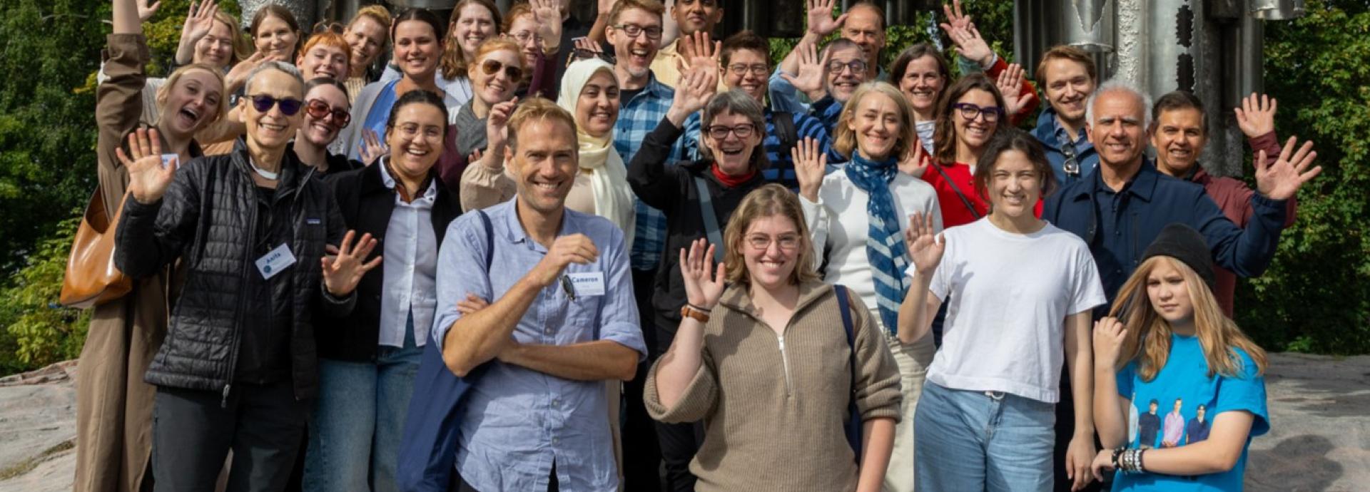 U.S. grantees smiling and waving in front of Sibelius monument