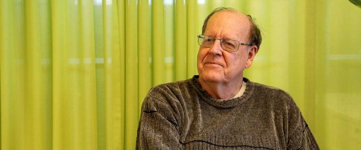 Professor Jim Fairweather in front of a lime green curtain