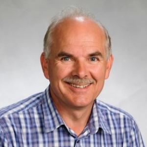 Photo of a short-haired man with a blue shirt