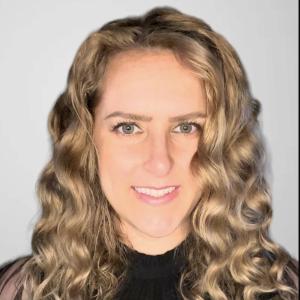 Woman with long light curly hair smiling