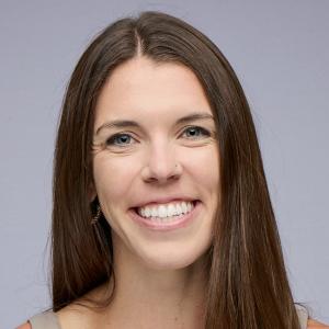 Person with long brown straight hair smiling at the camera