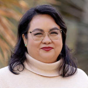 A person wearing glasses and a turtleneck sweater