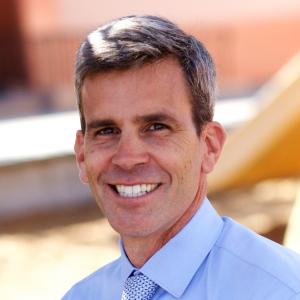 A person wearing a blue shirt and tie