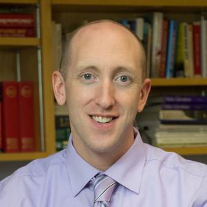 A person in a light purple shirt and tie