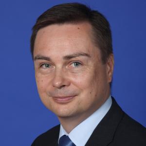 Man in suit in front of blue background
