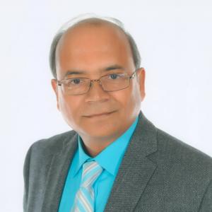 Person wearing grey suit jacket and bright blue shirt