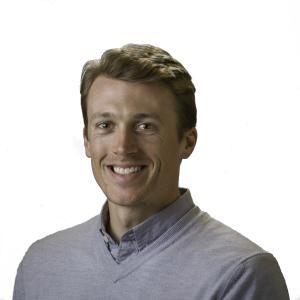 Person in a grey shirt smiling