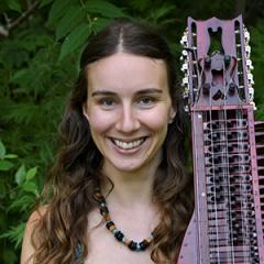 Headshot of Alyssa Rodriguez with her nyckelharpa