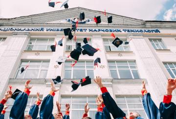 Graduation caps in the air