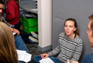 Group of MIT students discussing intensily