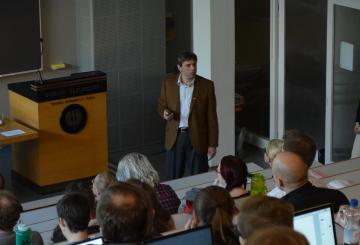 U.S. scholar lecturing in a full lecture hall